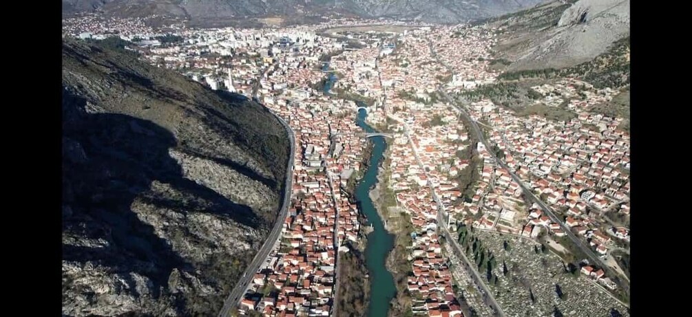 A mountainous town with a river running through it. 3