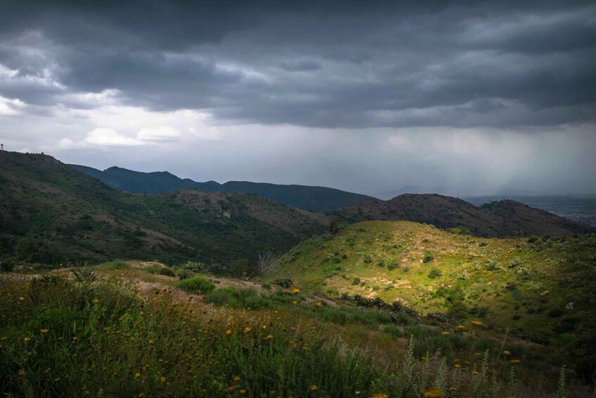 A mountainous landscape with a cloudy sky. 3