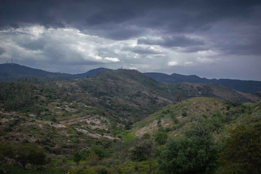 A hilly landscape with a cloudy sky. 4