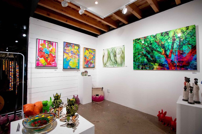 An art gallery with colorful paintings and sculptures on display. 1