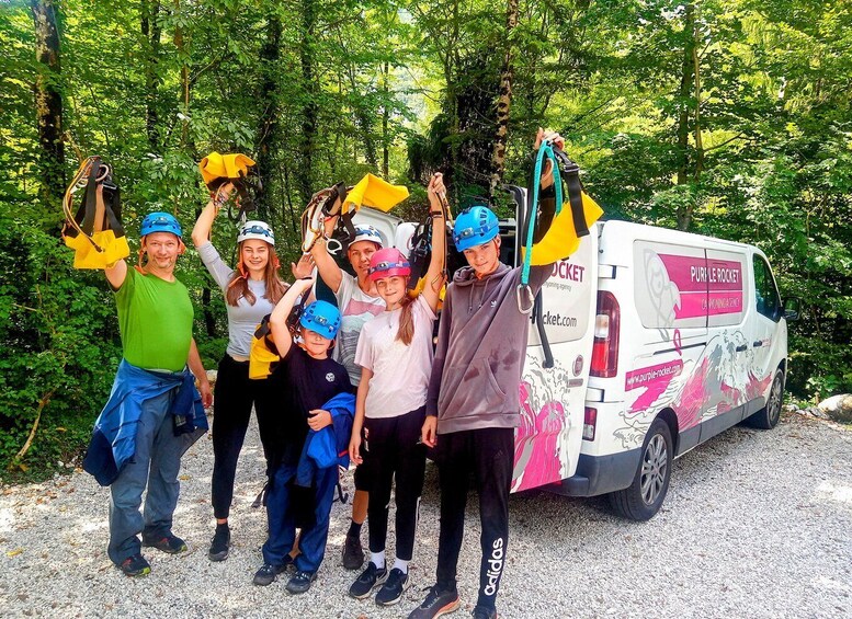 A group of people with helmets and harnesses, standing in front of a vehicle with 'Purple Rocket' branding. 4