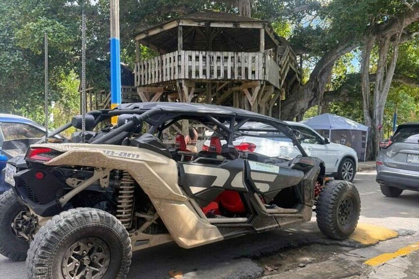 A dune buggy parked on a street with a wooden structure in the background. 4