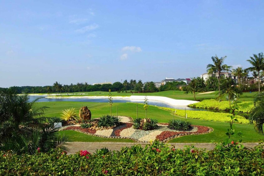 A golf course with a water hazard, sand bunkers, and tropical landscaping. 3