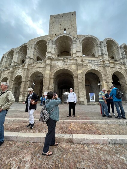 A historic stone amphitheater with multiple arches and a central tower. 2