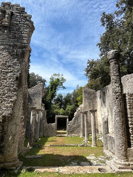 Ancient ruins with stone columns and a central doorway. 5