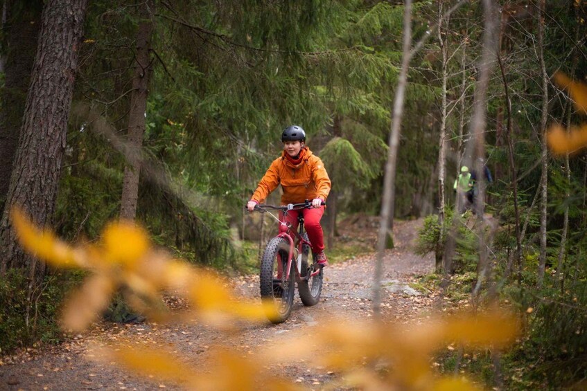 A person riding a mountain bike on a forest trail. 5