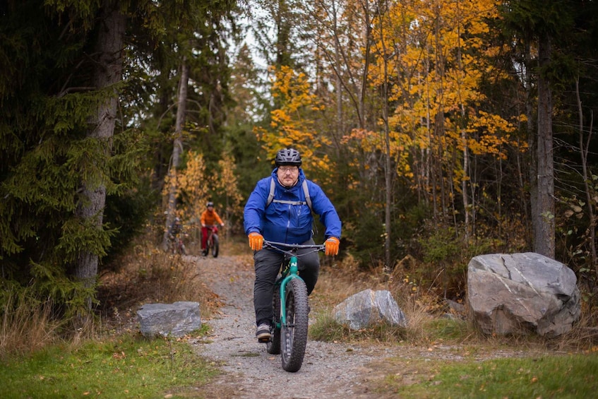 A person riding a mountain bike on a forest trail. 1