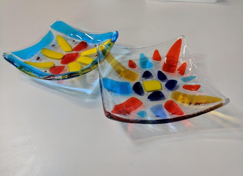 Two colorful glass art pieces with a variety of shapes and colors. 3