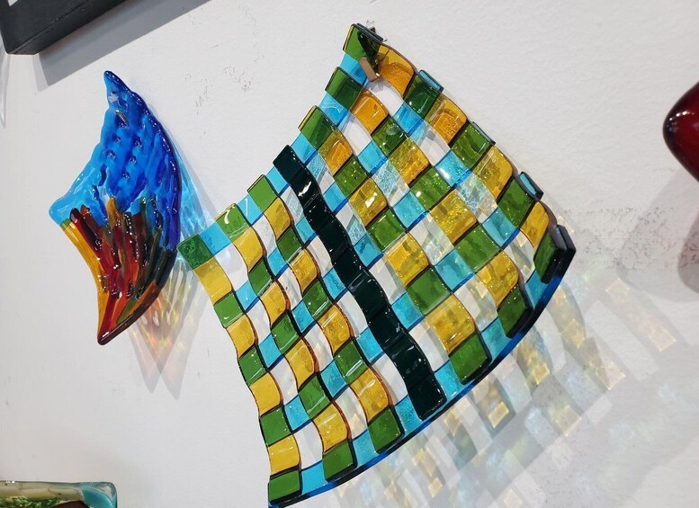 A colorful mosaic artwork with blue, green, yellow, and black tiles. 5