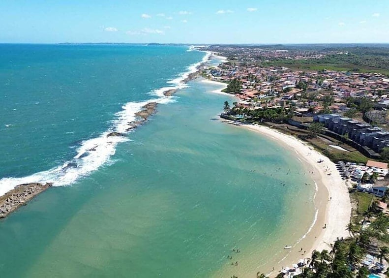 A coastal town with a beach, ocean, and residential area. 4