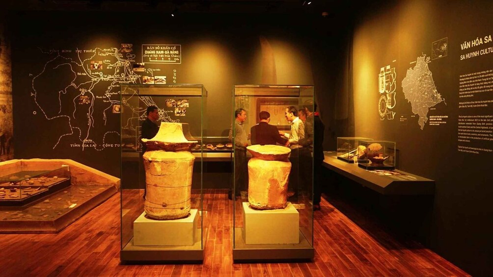 An exhibition with ancient artifacts, including pottery and a map of Vietnam. 3