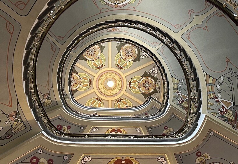 A grand, ornate ceiling with intricate patterns and a central circular design. 1