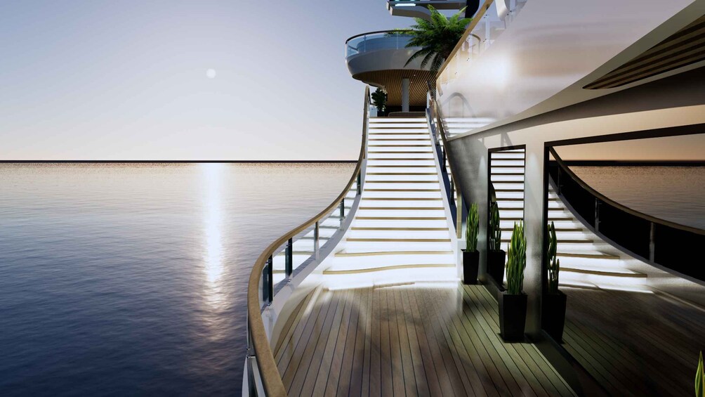 Een houten terras met een gebogen trap naar een glazen balustrade met uitzicht op zee. 4