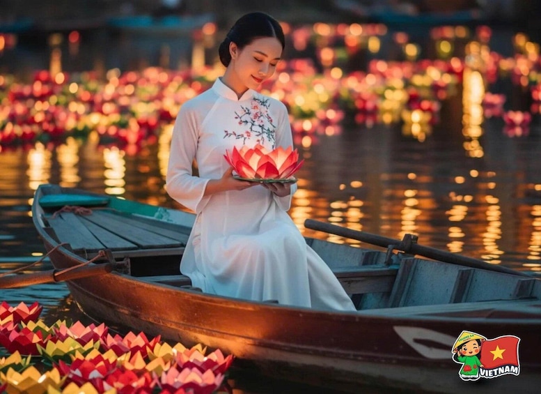 A person in a boat holding lotus flowers, surrounded by water and lotus decorations. 4