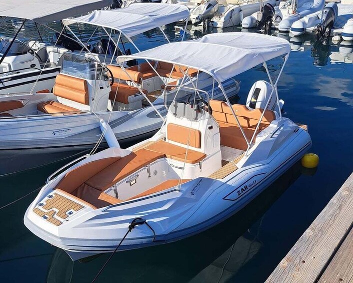 A marina with several motorboats docked. 5