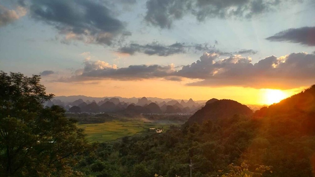 A mountainous landscape with a sunset. 1