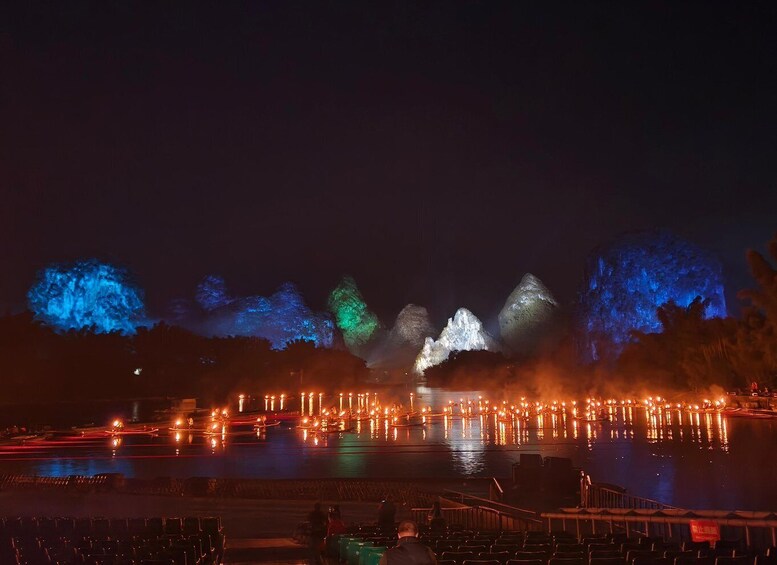 A nighttime water fountain display with illuminated water jets and a reflection on the water surface. 2