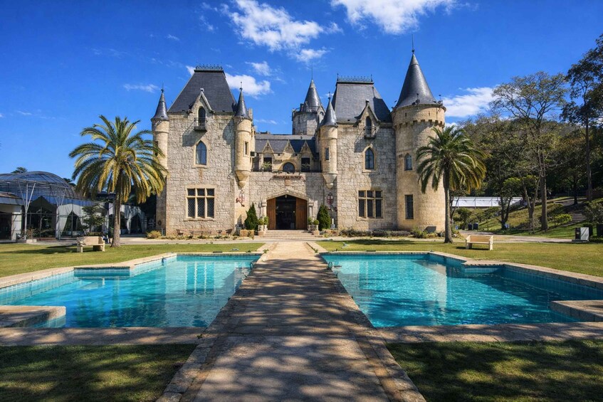 A castle with a swimming pool in front. 4