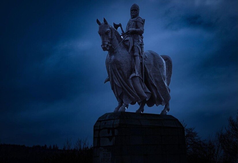 A statue of a mounted figure on a pedestal with a cloudy sky in the background. 4