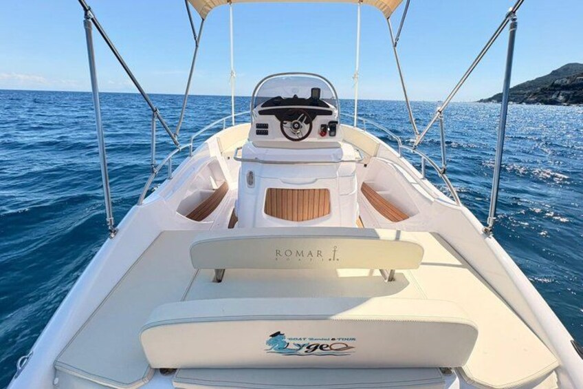 A boat with a white hull, a cabin, and a logo that reads 'ROMAR.' 2