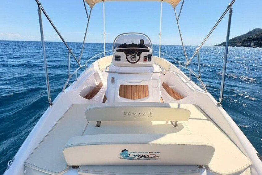 A boat with a 'ROMAR' label on the stern, a 'Vygoc' logo on the bow, and a clear blue sea in the background. 2