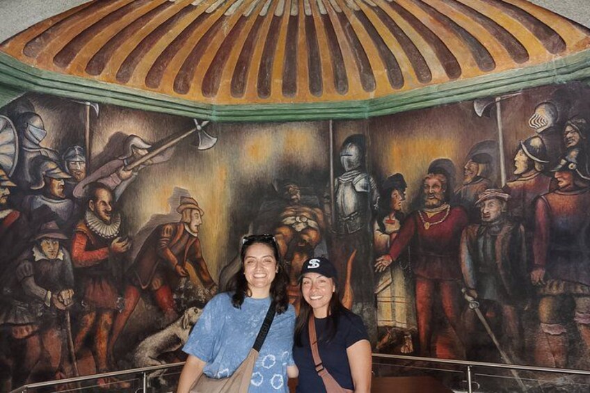 A mural with historical figures and a domed ceiling. 3