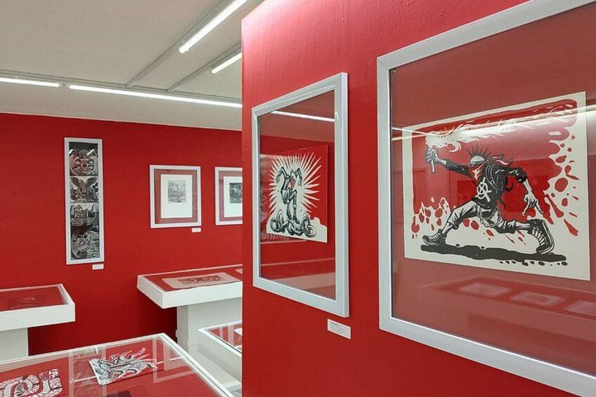 An art gallery with red walls and framed artworks. 5
