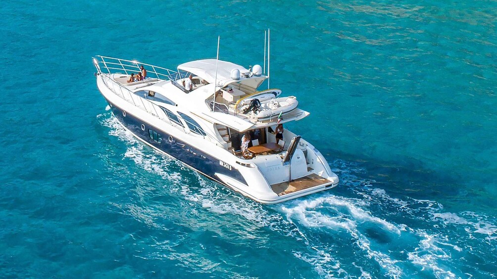 A large yacht with multiple decks and passengers enjoying the sea. 5