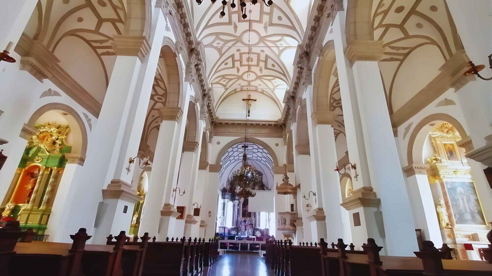 A church interior with high ceilings, arched windows, and a central altar. 4