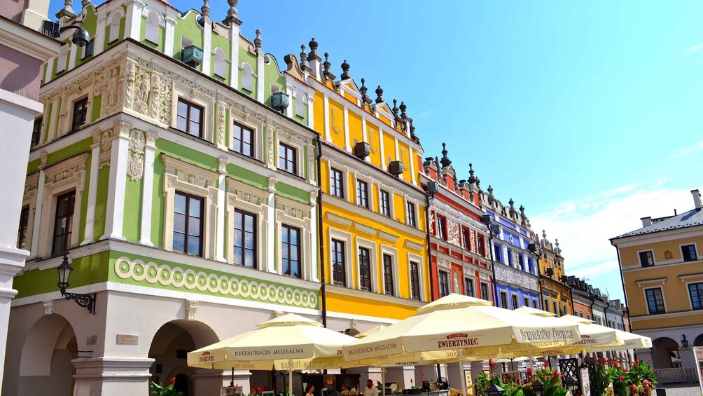 A row of colorful buildings with ornate facades and a clear blue sky. 3