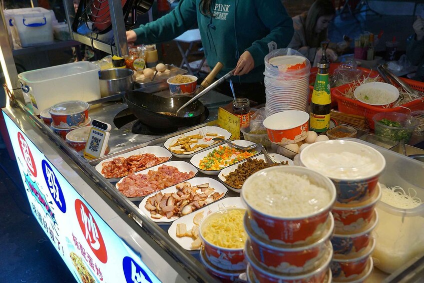 A food stall with various dishes and condiments. 4