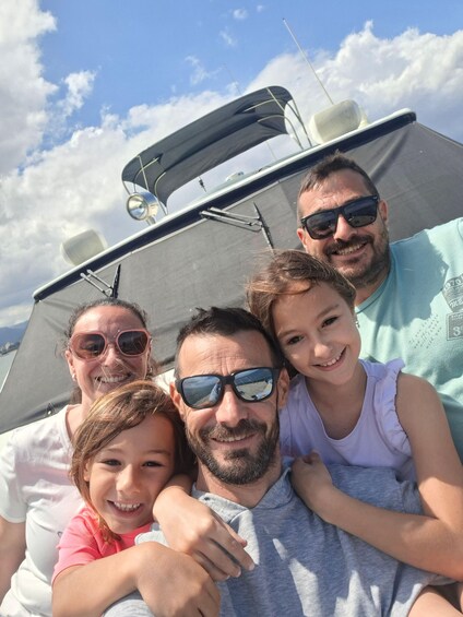 A family on a boat with a clear sky and clouds. 4