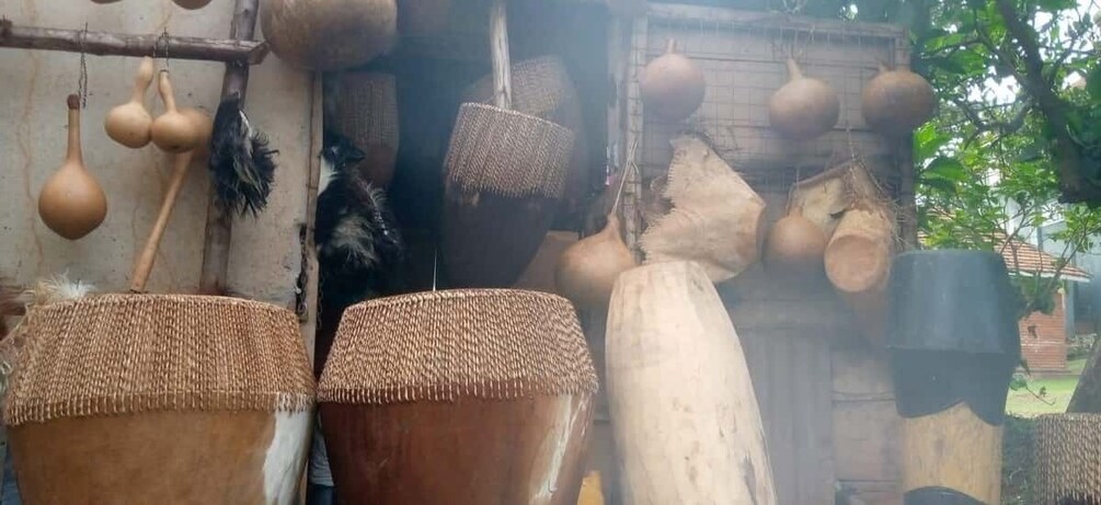 A rustic setting with woven baskets, hanging gourds, and traditional pottery. 1
