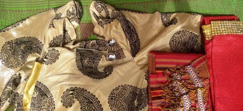 A beige fabric with black paisley patterns and a red fabric with a striped pattern. 3