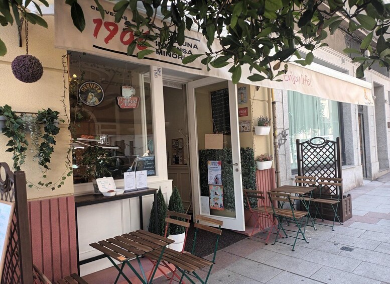 A café with outdoor seating, a sign reading '1906', and a 'Coffee House' sign. 5