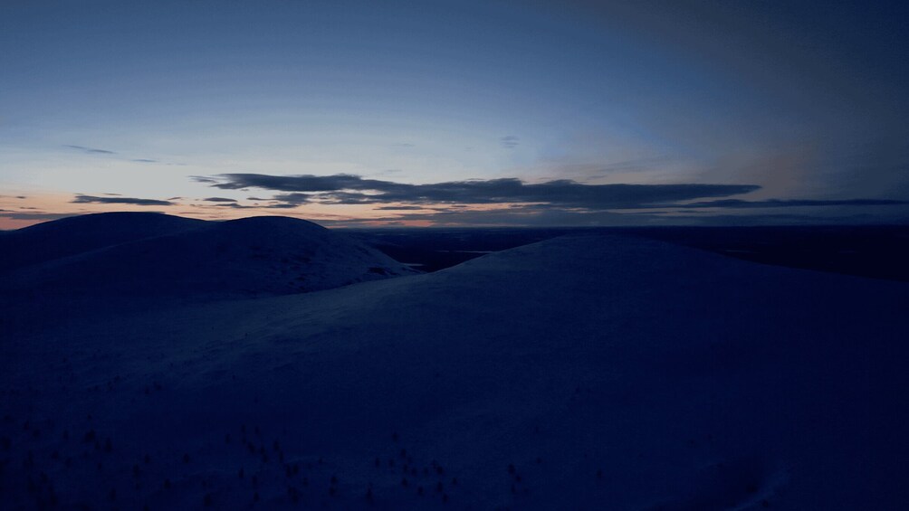 Snow-covered hills under a twilight sky. 2