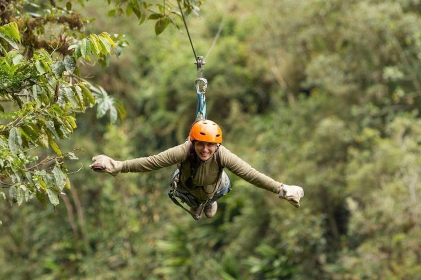 A person zip-lining through a forest. 2
