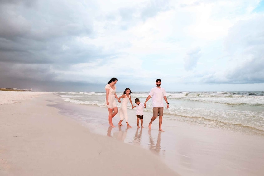 A family walking on a beach with waves in the background. 1