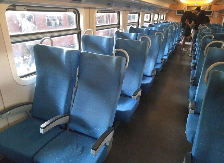 A train interior with blue seats and windows. 2