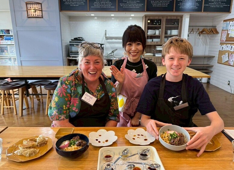 Three people in a restaurant with food on the table. 2