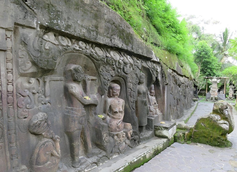 Ancient stone carvings and statues along a pathway. 3