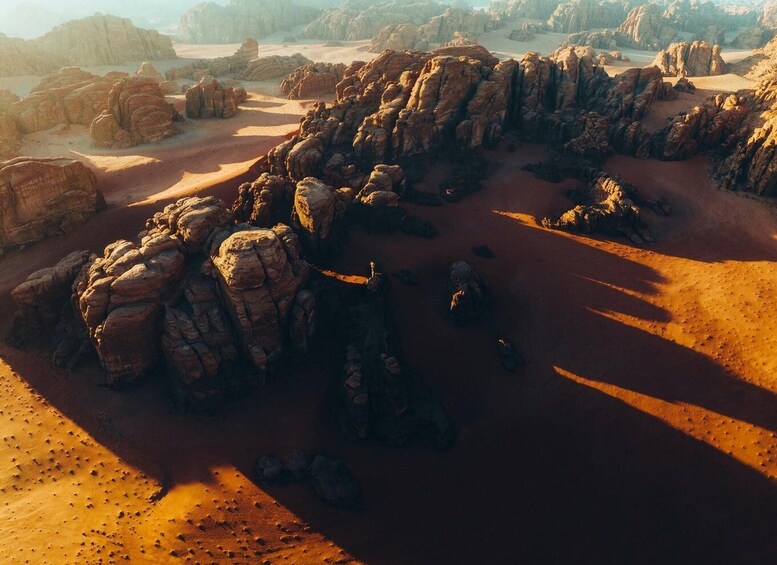 A desert landscape with prominent rock formations and a winding path. 3