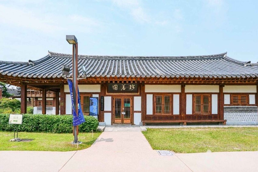 A traditional Korean building with a tiled roof and wooden structure. 1