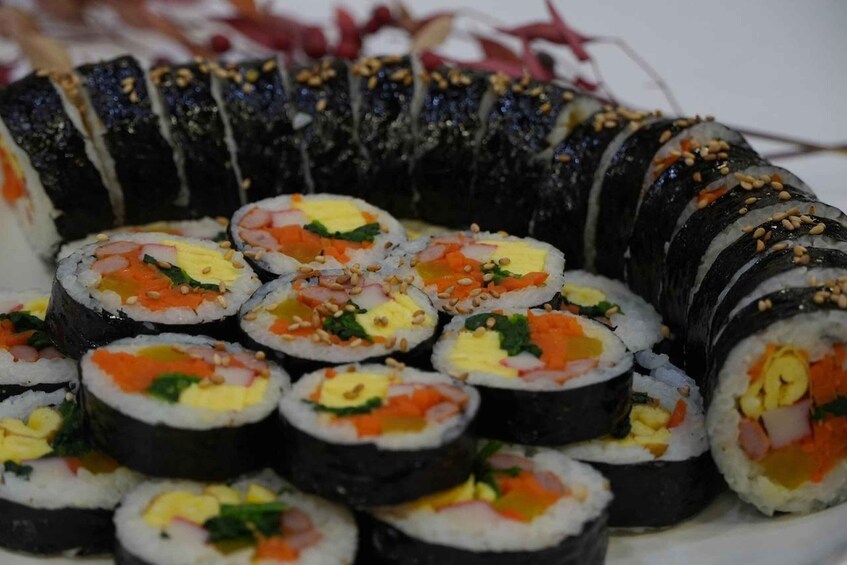 A variety of sushi rolls, including nigiri and maki, with visible ingredients like fish, avocado, and vegetables. 2