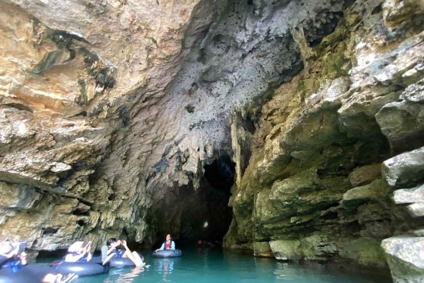 People floating in a cave with water. 3