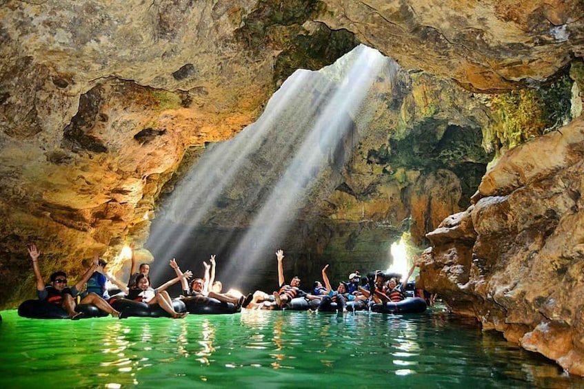People rafting in a cave with a waterfall. 5