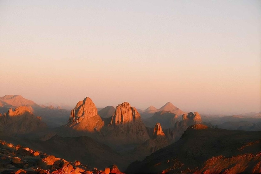 A mountainous landscape with prominent peaks during sunset. 3
