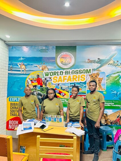 A promotional display for World Blossom Safaris with travel brochures and a backdrop featuring safari scenes. 2