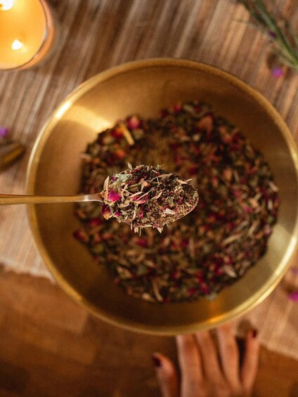 A bowl of dried herbs and flowers. 3