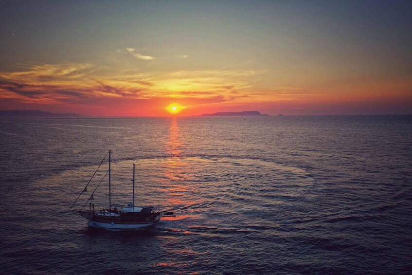 A boat on calm sea waters during sunset with a clear sky. 2